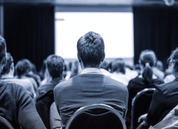 Business and entrepreneurship symposium. Speaker giving a talk at business meeting. Audience in conference hall. Rear view of unrecognized participant in audience. SSUCv3H4sIAAAAAAAACoxXS4+kNhC+R8p/aHEeFNs8DDkm2pwjRTmtcjB20VgDGGEzs6PR/vcUdNNtbFbJDZfrXV9Vmc+ff7pckkZYLZNfL5/rCc+67xfrZuG0GZFMXu70GUYFs08BpZ2Zteh9YiOc7EYxABLHpe9X8vftMrFOuMWC9Yw1+mqdka9TZ5xBOt3VTPqbEyvBk5fCwRUNHjXc3f96O1/2i+0SJfAq+aIWeYvnxbu0S7Ne/iU7Y/qXy++m7+EKL5e/R/0Gs9Xu4wJOJrvEzYkfWPhtsXoEa3/5Q49ilHBm6E8wUw9PfbePf/aIxRVG+fGMbCX1YvjwY0OaKhrFmYBU1oSkOVd12rA6SxXQtpaqIjmtD9Ylz/JSZSyVKi/SXPEiFSxv0yZTjEFDGqL4w6ndm5PS+E7s4R4MfXnA4USbgslgSjdlNtBG6UEPPXVHzSAG6/QGLF/6IHs48PpMke0W57C+a2yBqvzJf/v47qFvhh7EDb1fb+qS13dUNPho7EG6ZT64mNSs4OzpWFIyVhRJUP1mz6gvWZK8piGnNGML2IwIMp+XUUa4n8mEV4xVobSdQLxubfwUpaSuycFDXrAskoQBsT2fhBYwwhuMLoiDlFEc72Z+tZ2ZAs6SRZxO9IdKJWVV8YgLHk0epjA/JIVyEooOAE6P16NgUVWZnxP0LBK0H8MK62U4LUWUevMKmP/Zhj7yvOCkPCn0mskwov9ZaJS+ziGgcpKTMovAN4nZaaknMbojP80ylmc/wuq7GcTRt7rOSMSOu0SPYXqxDmXk8zSbFvVixNtO8TJEiyyPIxSyi/RyRiPOBndGG3KeY3d0M0zYXbAckV4xgopj5IgR5/YcOkujJAgpFByHOTJi3UPGVsildyFjmZU+Fs8E9YjT0S0uGD6cFXXIujw23NEMIxU/mFnNRjUCi1mKO63Kch45NRt8SgTtwSvCosRPS9Mf93hSlzmPIXJbosF0IVHJrVtUmMQKe8yLDkdDpF4sSkejtcQ2oOcFDVwOp01k8yyjSlu5bKgPdGWsPgsrnK6UZOSx6rxxfaaSluUZbuZF4uqOMHfYCXiOjAjcpPGEKgnLI9Ye/Qn5tgocF2PkHiJ6f2N6Ia/jI+ox+Db1OGrCMEjUtQ5wcoSuFBHbfZlfOtEH4+hsg0uzzBb+e8i1MIgAwXVZnBRwAgi9PNt77512cLFyBjiGTnGJ5w927yWzgtx4j5Y3I0W/Dv7MY5pm3AjbyPy8U4zrtkn3+QwYp+XaZAnDhn5kzZhJNFuELaqFnd4JBMAyqp3u2UL4OzN4qiczquLwFMbw8PW/CieM0CIlLGX7tPFfaaNx2xPt/hJMFEqtR5oxWpR1icjhuC8LHFX+T0mn0YMtlt2FZeoNdvhq8elF9LtScIqxF0XxRPHjz2W/K2MvNyVabS/HO0lvsVEomrrlJBU4I9O8rkRaZ5SmCpd+1uYty6v1D+L7vwAAAP//AwDQB+fTuw0AAA==